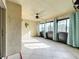 Sunroom features tile flooring, ceiling fan, and large windows at 2 Escondido Cir # 190, Altamonte Springs, FL 32701