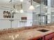 Wet bar with glass shelving and granite countertop at 2 Escondido Cir # 190, Altamonte Springs, FL 32701