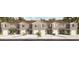 Three-unit townhome building with attached garages and neutral color scheme at 2770 Puffin Pl, Davenport, FL 33837