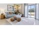 Relaxing living room with sectional sofa, ottoman, and access to a patio at 2770 Puffin Pl, Davenport, FL 33837