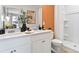 Modern bathroom with double vanity and an accent wall at 2774 Puffin Pl, Davenport, FL 33837