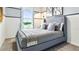 Cozy bedroom with gray bedding and window views at 2774 Puffin Pl, Davenport, FL 33837
