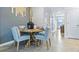 Cozy dining area with round wooden table and four light gray cushioned chairs at 2774 Puffin Pl, Davenport, FL 33837