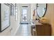 Contemporary entryway showcasing a wood console table and a modern mirror at 2774 Puffin Pl, Davenport, FL 33837