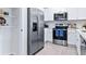 Modern kitchen with ample storage, stainless steel appliances and white cabinets at 2774 Puffin Pl, Davenport, FL 33837