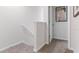 Upstairs hallway with carpeted floors and a door at 2774 Puffin Pl, Davenport, FL 33837