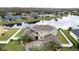 Stunning aerial view of a large home by the lake at 3301 Buckingham Way, St Cloud, FL 34772
