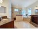 Elegant bathroom with soaking tub, walk-in shower, and double vanity at 3301 Buckingham Way, St Cloud, FL 34772