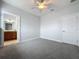 Simple bedroom with ceiling fan and access to bathroom at 3301 Buckingham Way, St Cloud, FL 34772