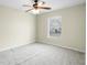Well-lit bedroom featuring a ceiling fan and carpet at 3621 Ronda Dr, Deltona, FL 32738