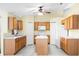 Kitchen with light wood cabinets, an island, and white appliances at 3621 Ronda Dr, Deltona, FL 32738