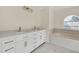 Bathroom boasts double vanity, a large soaking tub and marble-look floors at 415 Big Sioux Ct, Kissimmee, FL 34759