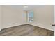 Bright bedroom with wood-look floors and large window at 415 Big Sioux Ct, Kissimmee, FL 34759