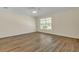 Spacious bedroom with wood-look floors and a ceiling fan at 415 Big Sioux Ct, Kissimmee, FL 34759