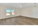 Large bedroom with wood-look floors and a window offering natural light at 415 Big Sioux Ct, Kissimmee, FL 34759
