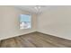 Well-lit bedroom, featuring wood-look floors and a window at 415 Big Sioux Ct, Kissimmee, FL 34759