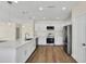 Well-equipped kitchen with white cabinets, quartz countertops and island at 415 Big Sioux Ct, Kissimmee, FL 34759