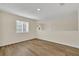 Bright loft area with wood-look floors and a window offering natural light at 415 Big Sioux Ct, Kissimmee, FL 34759