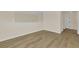 Spacious loft area with wood-look floors and access to a hallway at 415 Big Sioux Ct, Kissimmee, FL 34759