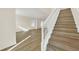 Wooden staircase with white railing leading to the upper level at 415 Big Sioux Ct, Kissimmee, FL 34759