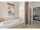 Bathroom with an oval bathtub, shower, and access to bedroom at 4459 Twinview Ln, Orlando, FL 32814