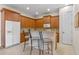 Bright kitchen features wood cabinets, tile backsplash, and breakfast bar at 4459 Twinview Ln, Orlando, FL 32814