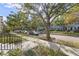 Tree-lined street with townhouses and parked cars at 4459 Twinview Ln, Orlando, FL 32814