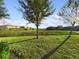 Spacious backyard with lush greenery and tranquil lake views at 4775 Terrasonesta Dr, Davenport, FL 33837