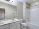 Bathroom with tub, double vanity, and toilet at 4775 Terrasonesta Dr, Davenport, FL 33837