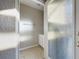 Clean bathroom with a single sink vanity and frosted glass door at 4775 Terrasonesta Dr, Davenport, FL 33837