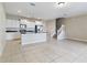 Open concept kitchen with island and stainless steel appliances at 4775 Terrasonesta Dr, Davenport, FL 33837