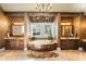 Luxurious bathroom with double vanities, soaking tub, and chandelier at 5271 Isleworth Country Club Drive, Windermere, FL 34786