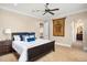 Spacious bedroom with a dark wood bed frame and ensuite bathroom access at 5271 Isleworth Country Club Drive, Windermere, FL 34786