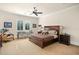 Bright bedroom featuring a large bed, a writing desk, and plush chair at 5271 Isleworth Country Club Drive, Windermere, FL 34786