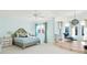 Serene bedroom with light walls, built in seating and large windows at 5271 Isleworth Country Club Drive, Windermere, FL 34786
