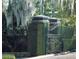 Elegant entrance with iron gate and hedges at 5271 Isleworth Country Club Drive, Windermere, FL 34786