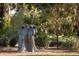 Serene garden with three hooded figures sculpture at 5271 Isleworth Country Club Drive, Windermere, FL 34786