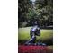 Landscaped garden with a bronze statue at 5271 Isleworth Country Club Drive, Windermere, FL 34786