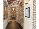 Long hallway with brick archways and hardwood floors at 5271 Isleworth Country Club Drive, Windermere, FL 34786