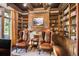 Spacious library with built-in bookshelves, fireplace, and comfortable seating at 5271 Isleworth Country Club Drive, Windermere, FL 34786