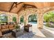 Covered patio with seating area and view of the pool and backyard at 5271 Isleworth Country Club Drive, Windermere, FL 34786