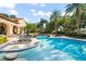 Luxury pool area with lounge chairs and lush landscaping at 5271 Isleworth Country Club Drive, Windermere, FL 34786