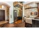 Wet bar with wine cooler, granite countertop, and glass enclosure at 5271 Isleworth Country Club Drive, Windermere, FL 34786