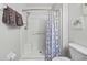 Shower stall with a patterned curtain and plenty of storage at 8443 Crystal Cove Loop, Kissimmee, FL 34747