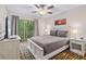 Bright bedroom with a comfortable queen-size bed and private balcony access at 8443 Crystal Cove Loop, Kissimmee, FL 34747