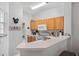 Well-equipped kitchen featuring wood cabinets and modern appliances at 8443 Crystal Cove Loop, Kissimmee, FL 34747