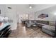 Open living area with a sectional sofa and views to the kitchen and dining area at 8443 Crystal Cove Loop, Kissimmee, FL 34747