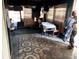 A room with patterned floors, a table, and clothes hanging to dry at 14917 Se 106Th Ave, Summerfield, FL 34491