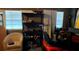 Small room with shelving, tools, a chair, and a lawnmower at 14917 Se 106Th Ave, Summerfield, FL 34491