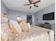 Bright bedroom featuring a king-size bed and ceiling fan at 231 Riverside Drive # 509-1, Holly Hill, FL 32117